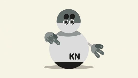 Irudian, bola formako robot bat ageri da, tripa seinalatzen.